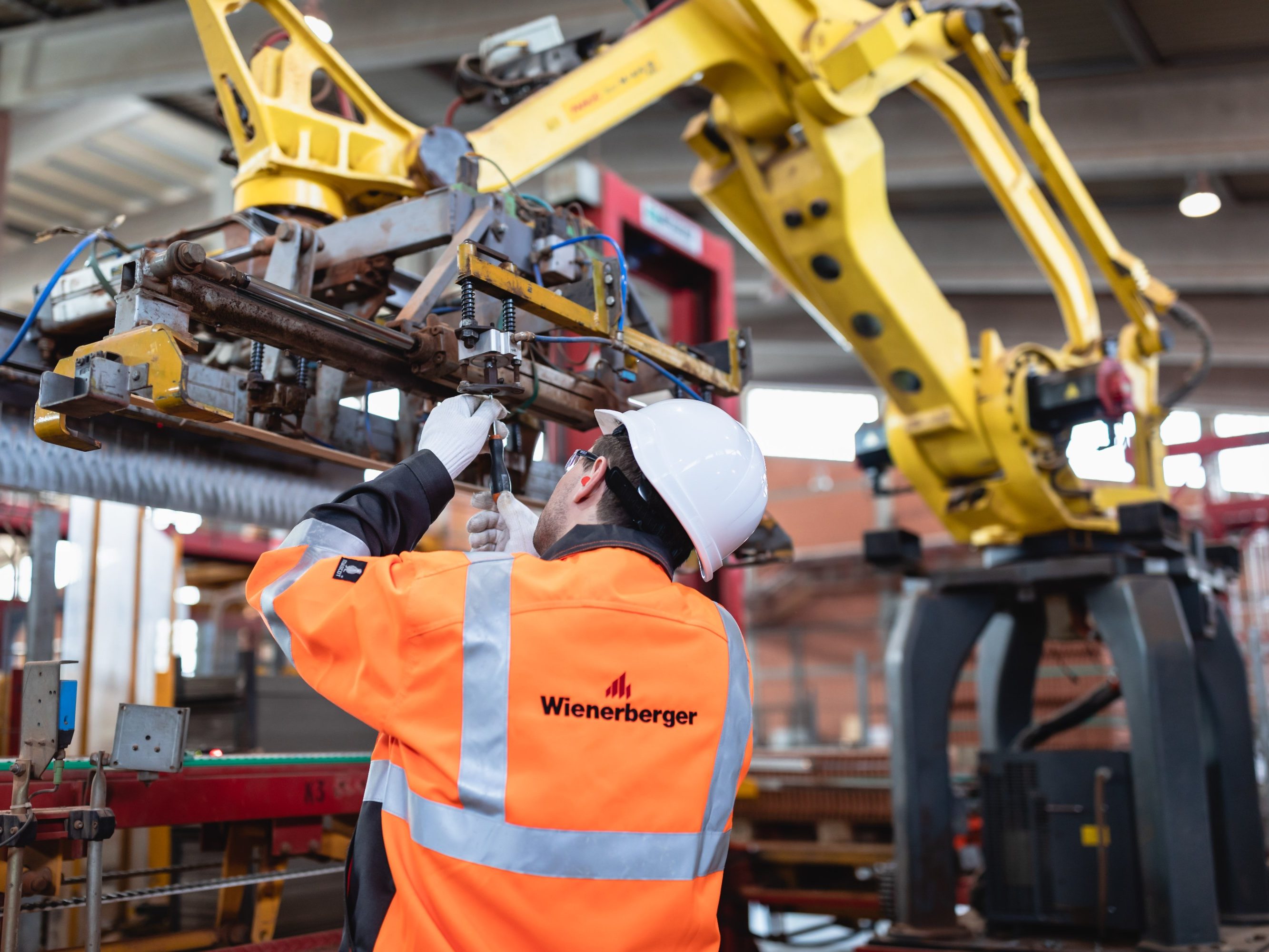 Factory worker maintaining machine